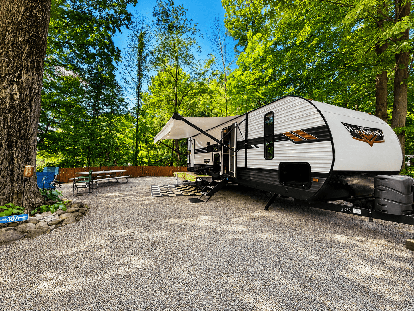 Cherry House set up at a wooded campsite with its awning extended